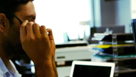 Tired-business-executive-sleeping-on-his-desk