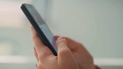 Detailed-close-up-of-hands-holding-and-browsing-the-internet-on-the-phone