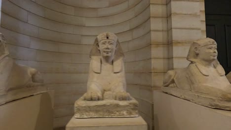 sphinx statues displayed in a museum hallway