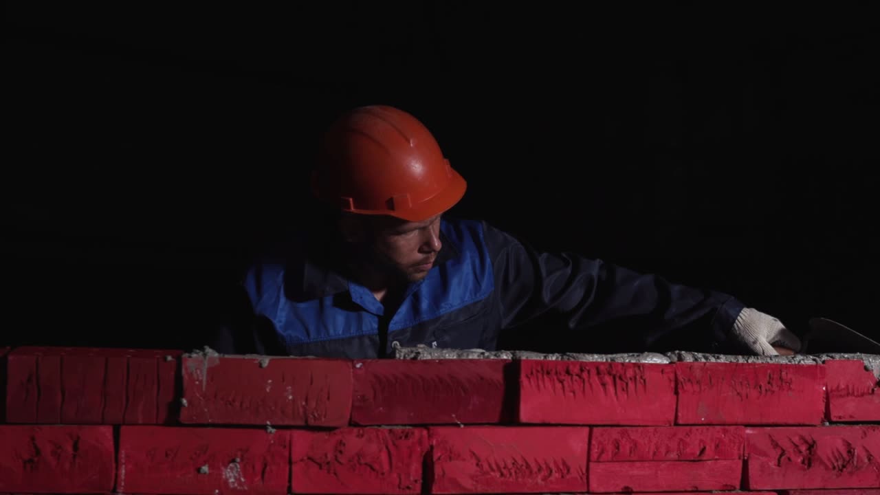 Construction Worker Laying Bricks