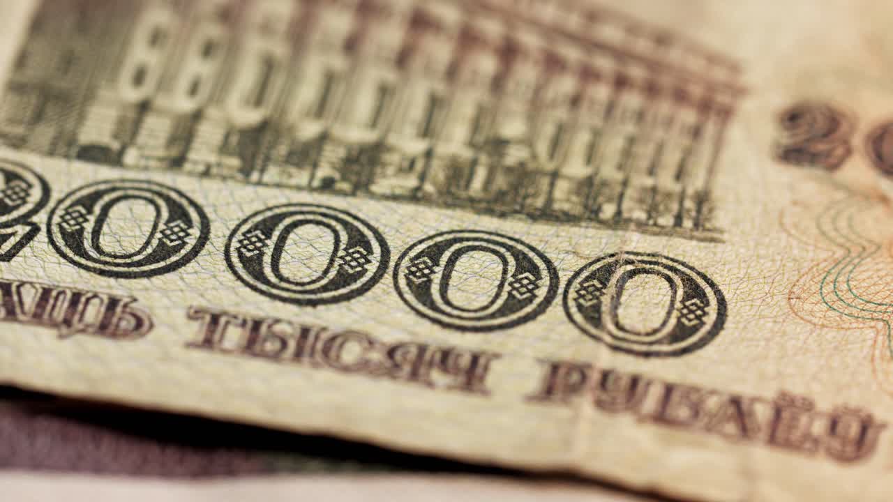 Static macro shot of different Belarusian ruble banknotes dropping into frame