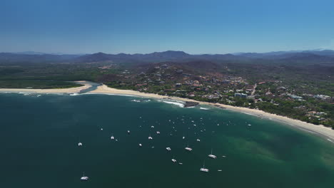 aerial view of a tropical beach with sailboats