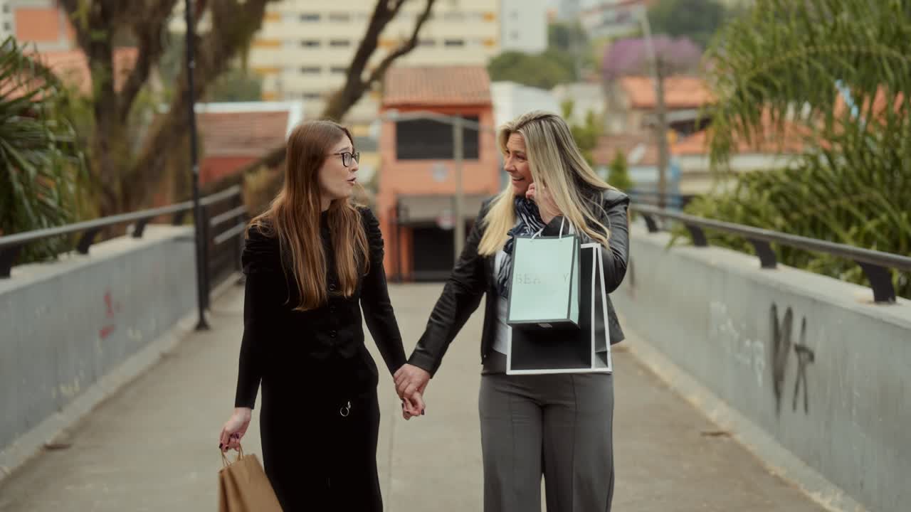 Two women walking and talking after shopping