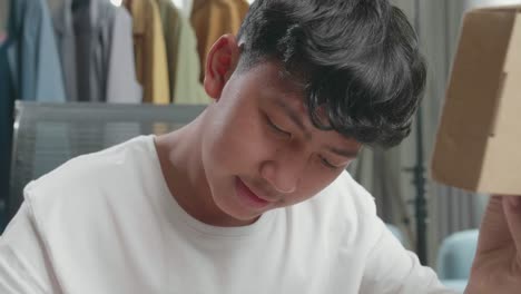 Teenager Looking Down at a Box