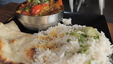 a tasty forkful of authentic indian curry tomato and rice, slow motion slider close up hd