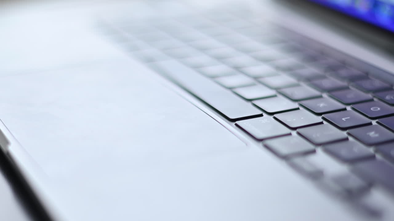 Laptop keyboard close-up with blurred details on a sunny day