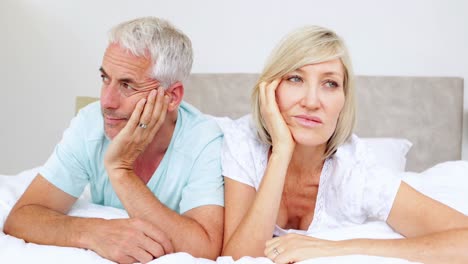 unhappy couple not talking on bed