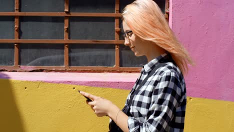 woman using mobile phone while walking outdoor 4k