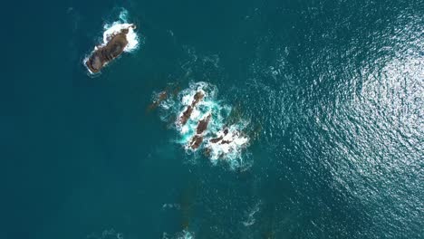 Ocean-Waves-Breaking-On-Rocky-Small-Islands-With-Clear-Water-And-Foam