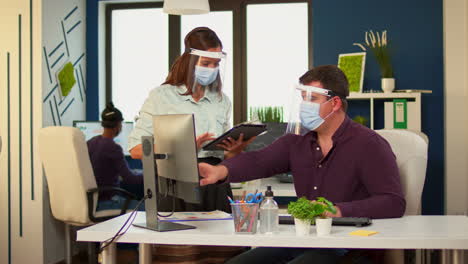 businessman with visor pointing on desktop explaining graphs