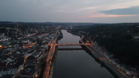 aerial of passau german city at night with sunset citylights and river