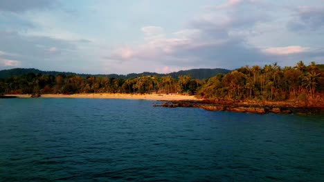 4K-Cinematic-nature-drone-footage-of-a-panoramic-aerial-view-of-the-beautiful-beaches-and-mountains-on-the-island-of-Koh-Lanta-in-Krabi,-South-Thailand,-during-sunset