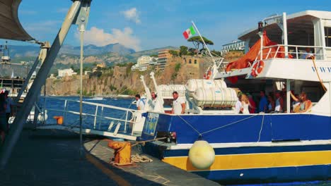 a boat docks at a scenic italian port