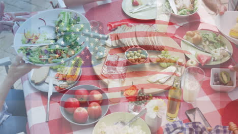 animation of flag of usa waving over table full of food