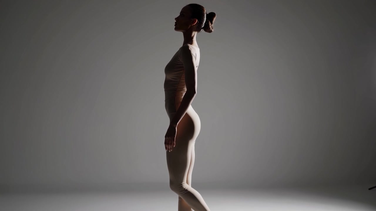 Elegant Woman Posing in Silhouette with Dramatic Backlighting in Studio