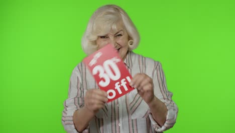 senior grandmother showing up to 30 percent off inscription signs, rejoicing discounts. black friday