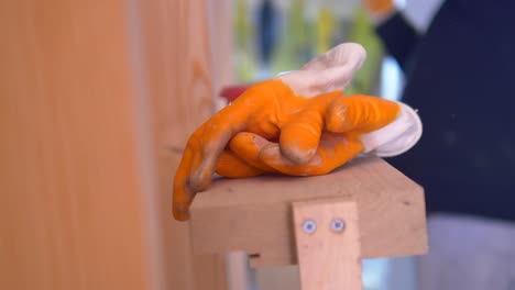 orange work gloves on wooden surface