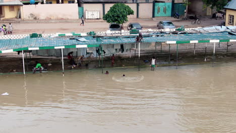 children playing in the river water; jumping, flipping, splashing and having fun