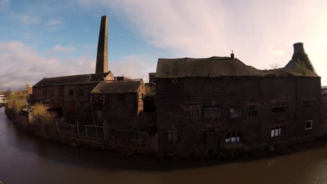 aerial footage of an old abandoned, derelict pottery factory and bottle kiln located in longport, stoke on trent, staffordshire