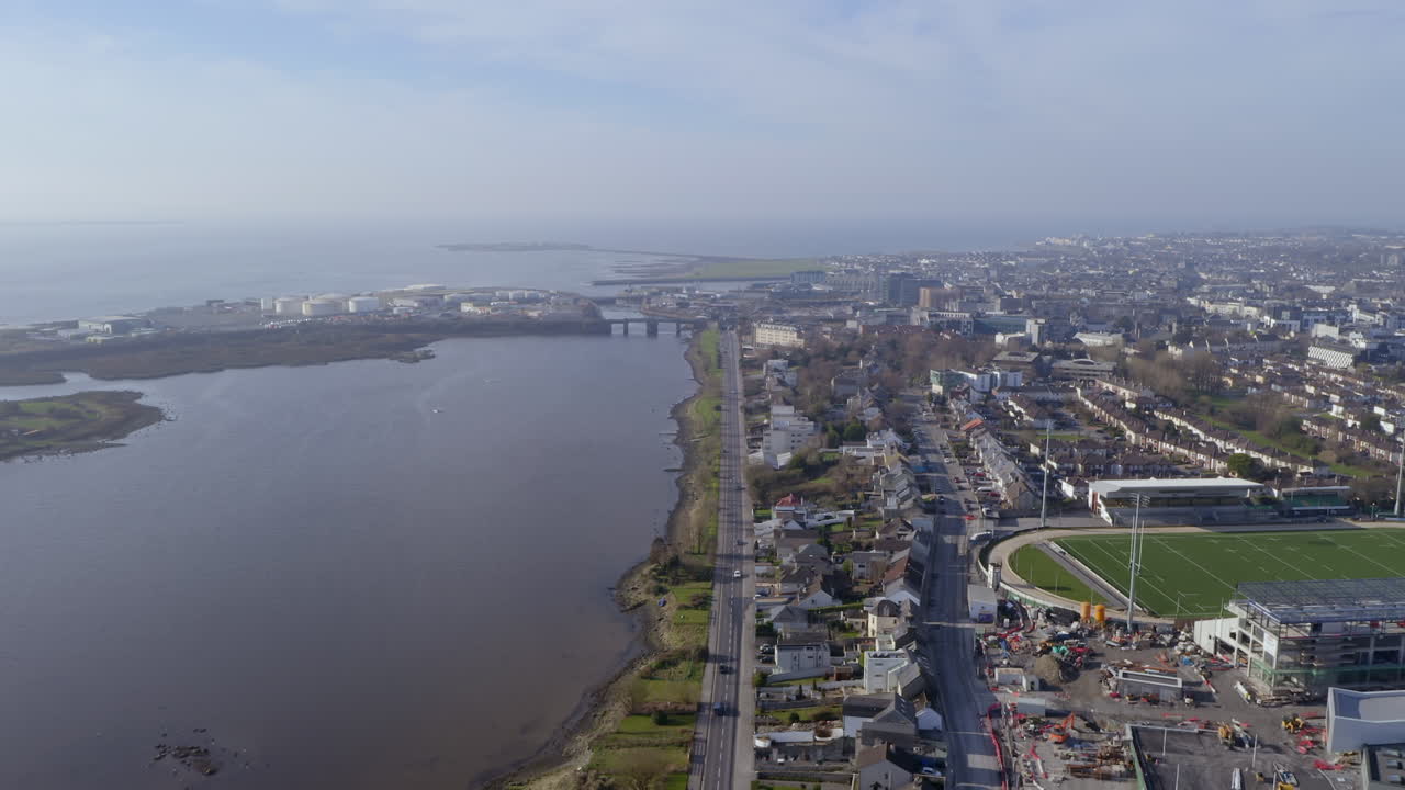 Aerial tracking shot capturing Galway’s picturesque views, featuring Lough Atalia in the foreground and Galway Bay in the background