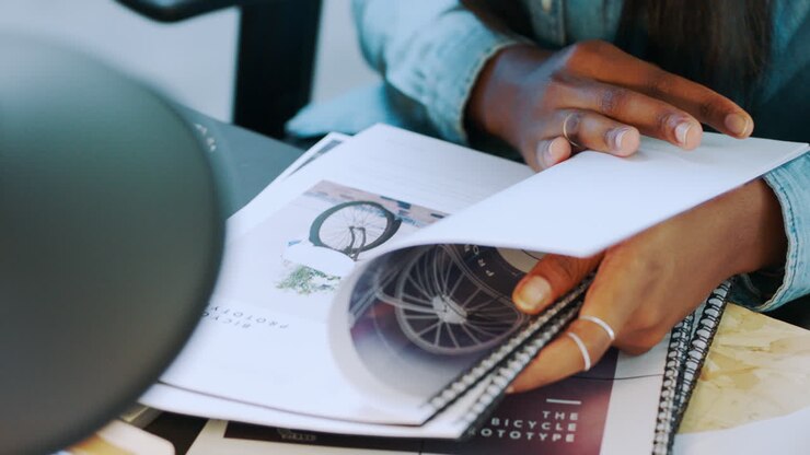 Black woman, designer and reading documents