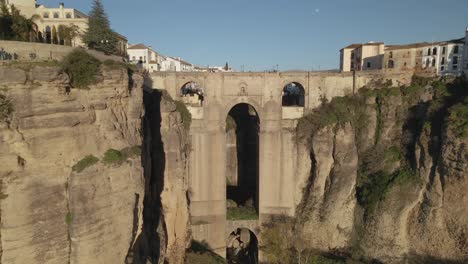 moving backwards fast from puente nuevo bridge, revealing the town of ronda, andalusia, spain