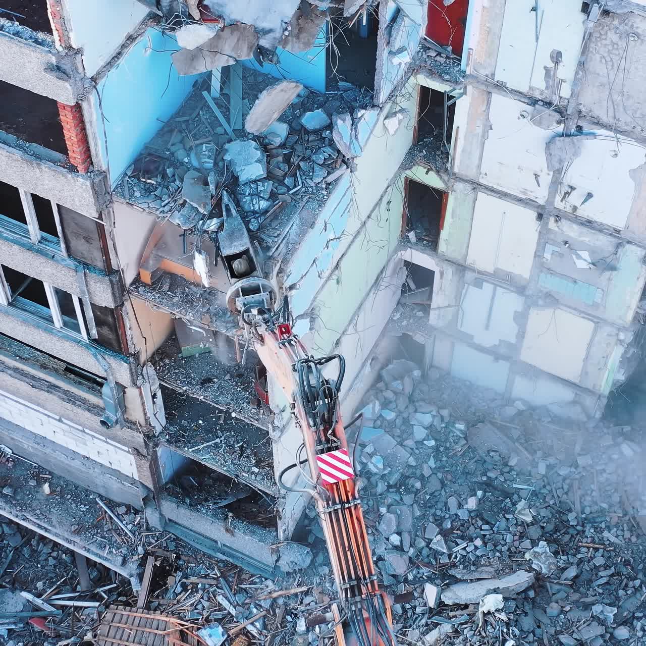 Aerial view of destruction by machine. Excavator demolition constructions
