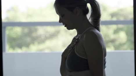 Side-view-of-pregnant-woman-practicing-breath-exercises