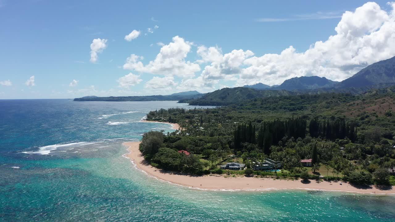Aerial wide descending shot of the picturesque Haena Beach along the coast of Kaua'i, Hawai'i