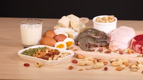 variety of protein-rich foods on wooden table