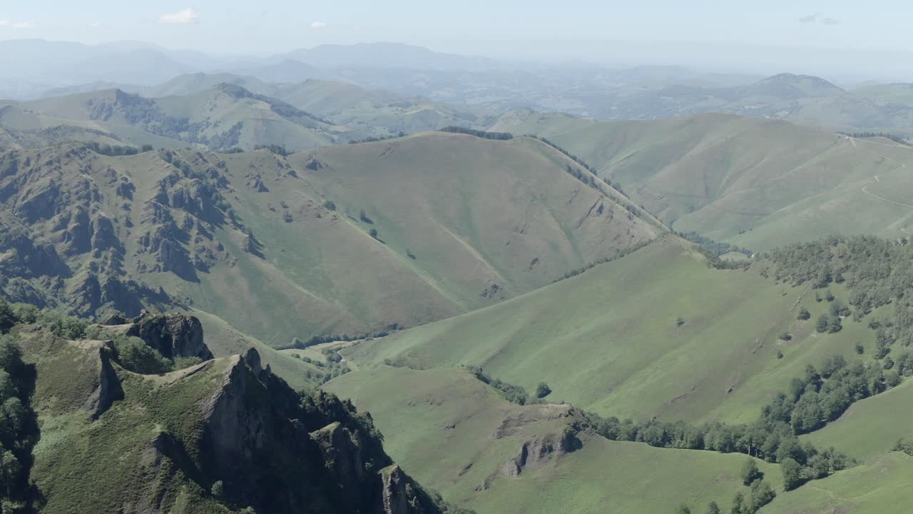 Aerial view of sweeping green valleys and rocky peaks in Pyrenees at Col de Sourzay, Lecumberry, ideal for nature and travel, France