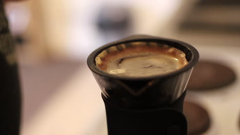 Close-up-shot-of-making-filter-coffee-at-home-with-V60-coffee-brewer,-wooden-stirring-stick,-speciality-coffee