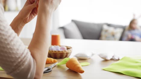 Tracking-video-of-woman-sews-carrots-at-home