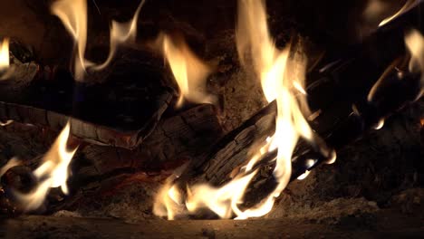 closeup of logs in wood burning stove. uk