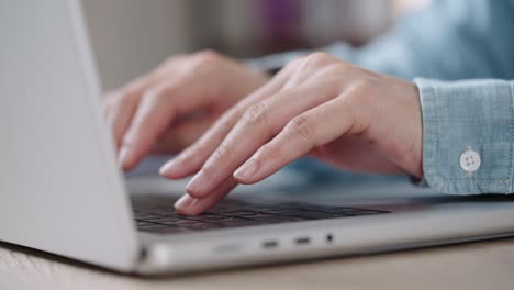 Close up Shot of Businesswoman hands typing on laptop computer keyboard for searching information,online communication support,marketing research,business report in the office desk at night.