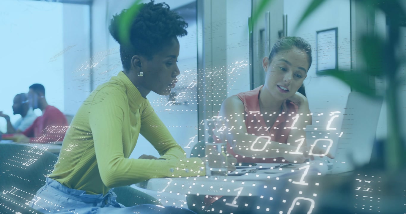 Women collaborating on IT project in lounge viewing binder as data overlay forming holographic data