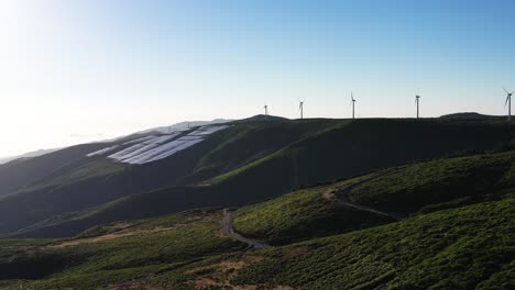 aerial view, array of wind turbines on hilltop in countryside landscape, madeira island, portugal, drone shot