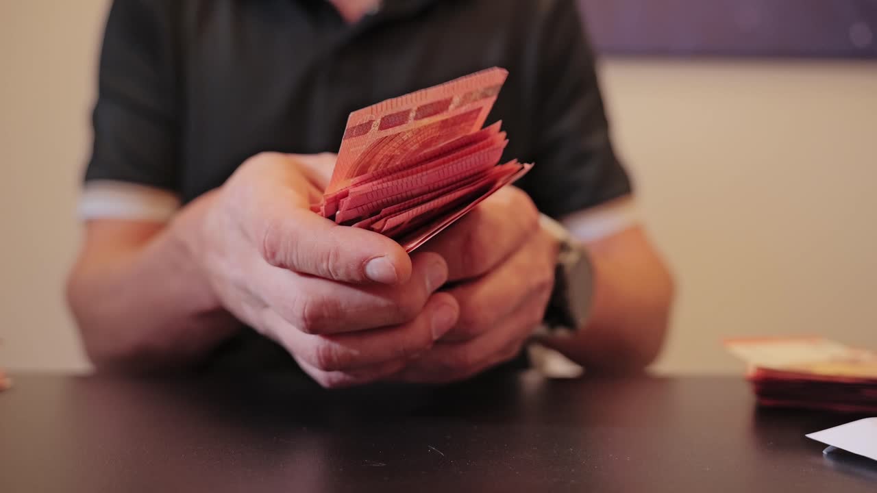 Tight focus on cash counting hands showing economic inequality and restraint