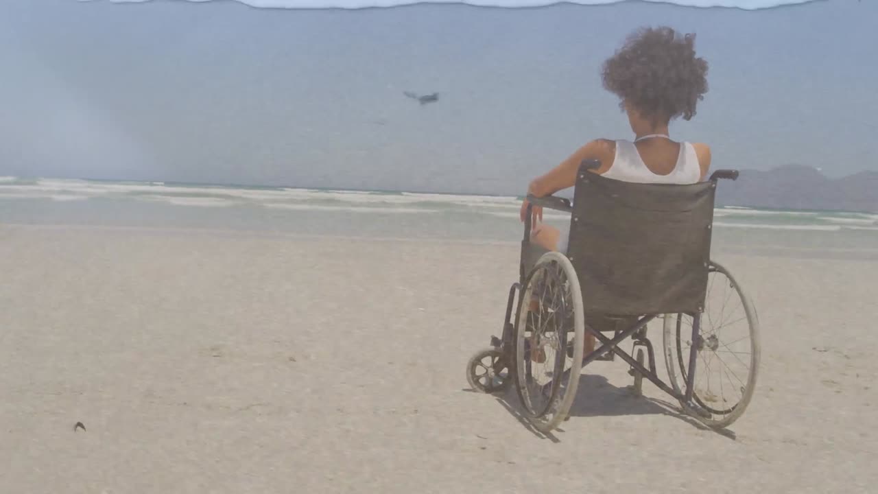 Animation of sea landscape over disabled african american woman sitting in wheelchair