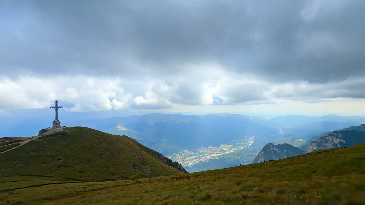 View on the cross installed on the top of the mountain. Heroes' Cross on Caraiman Peak in Bucegi mountains, Romania