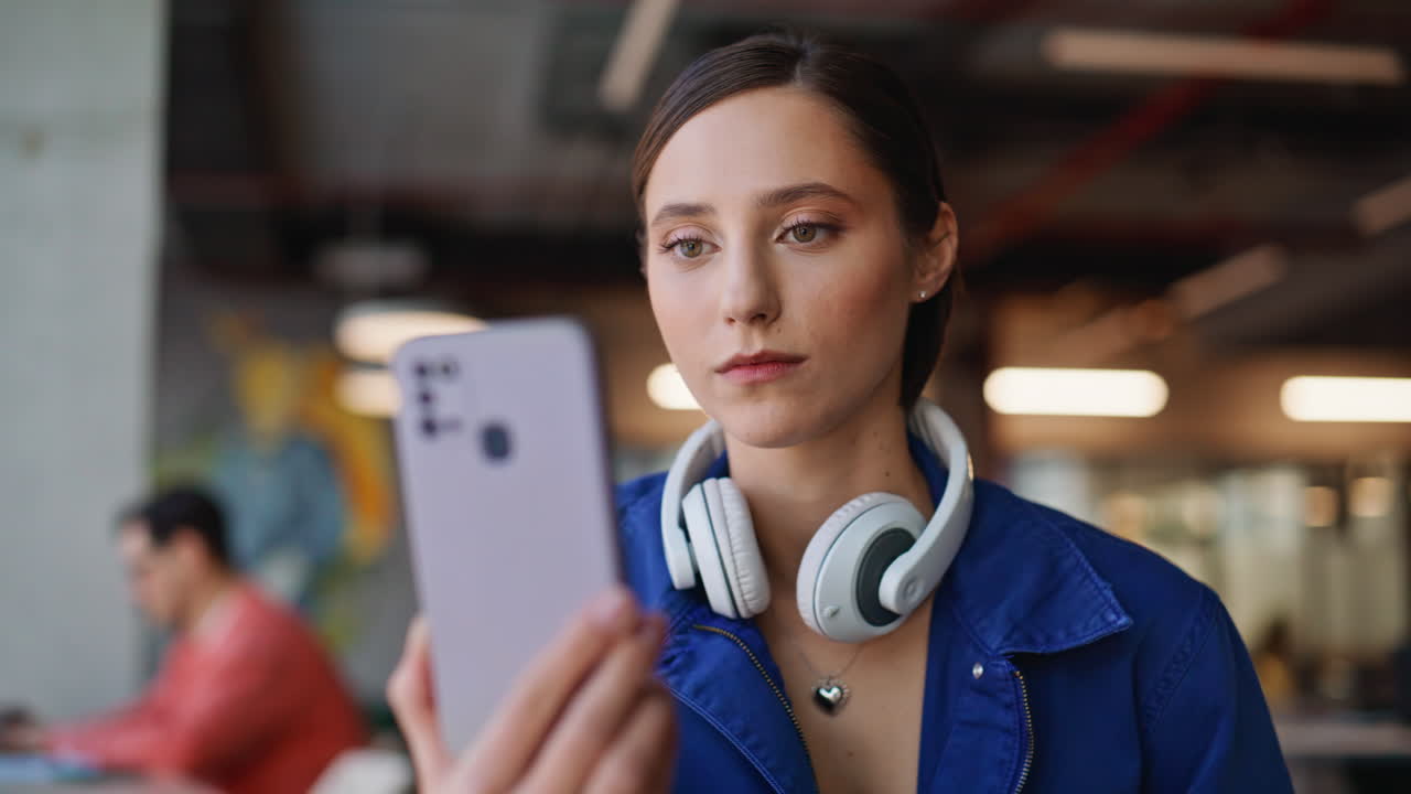 Happy lady reading message cellphone in cozy cafeteria closeup. Smiling woman