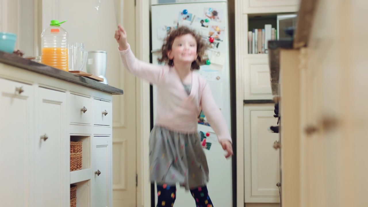 Young Girl Dancing and Playing in a Kitchen