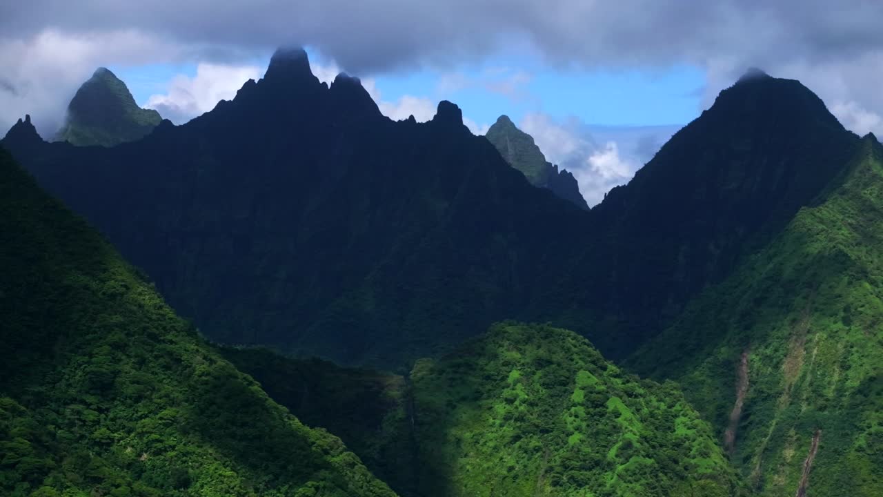 Dramatic Aerial View of Lush Green Mountains and Clouds