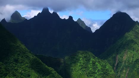 dramatic aerial view of lush green mountains and clouds