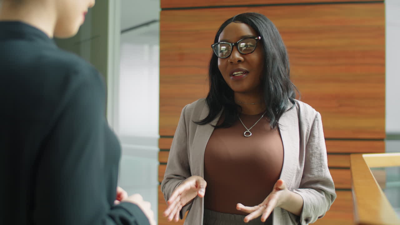 African American Business Lady Talking with Colleague