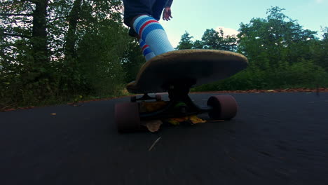 male-person-with-white-high-socks-longboarding