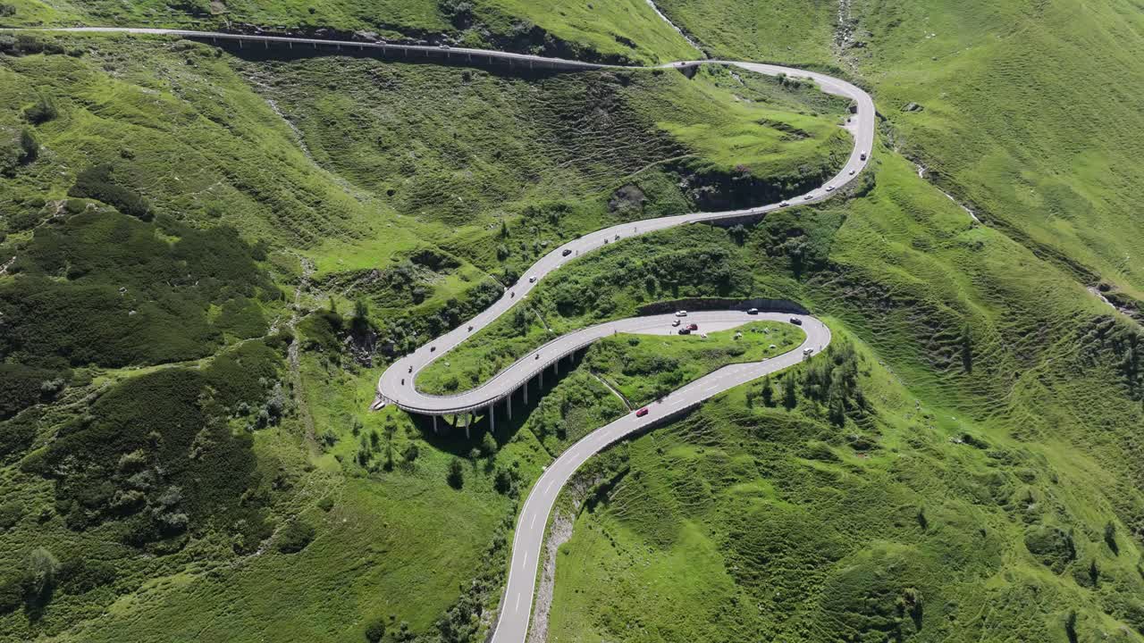 Drone ascends over the picturesque of Austria's famous mountain winding road - 4K
