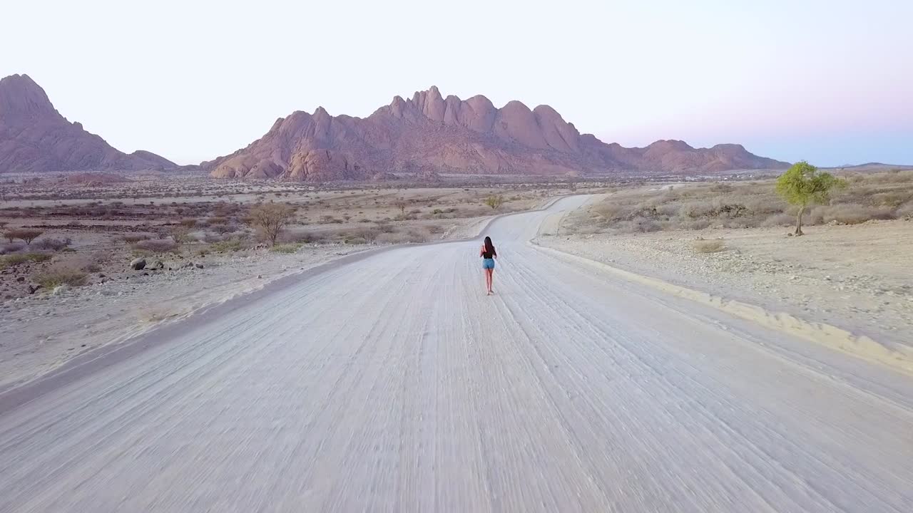 Aerial Over A Woman Running On A Dirt Road Near Spitzkoppe Namibia