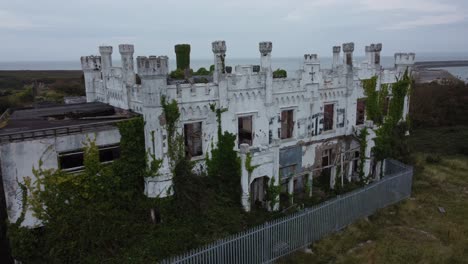 soldiers point house aerial view circling across abandoned secured holyhead victorian castle hotel