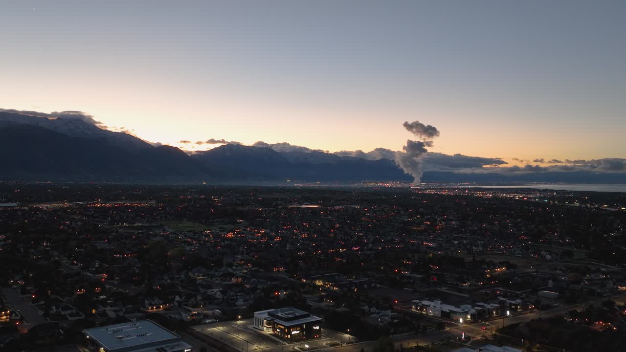 Pullback Aerial Of Office Buildings And Residential Streets At Dawn In The Utah Valley, Sun Rising Over Mountains